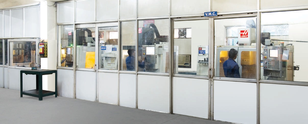 HAAS VMC machines behind glass enclosures
